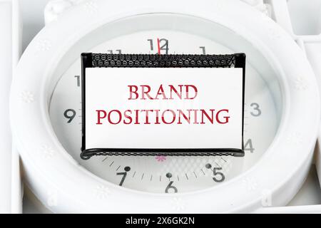 Brand positioning is shown on a business card on a stand on a lying watch Stock Photo