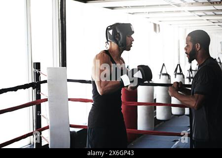 Boxing, men and fitness with training, exercise and motivation with wellness, endurance and challenge. People, coaching and athlete with energy Stock Photo