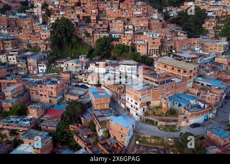 Aerial view of Caracas at sunset with the Petare neighborhood, the largest slum in Venezuela and latin america, with the Avila Mountain in the backgro Stock Photo