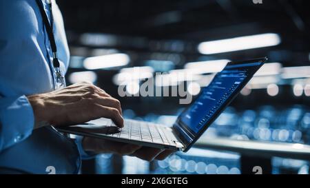 Data Center Programmer Using Digital Laptop Computer, Maintenance IT Specialist. Cloud Computing Server Farm System Administrator Working on Cyber Security for Iaas, saas, paas. Closeup Focus on Hands Stock Photo