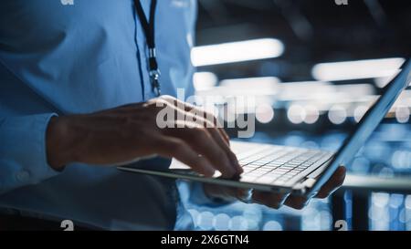 Data Center Programmer Using Digital Laptop Computer, Maintenance IT Specialist. Cloud Computing Server Farm System Administrator Working on Cyber Security for Iaas, saas, paas. Closeup Focus on Hands Stock Photo