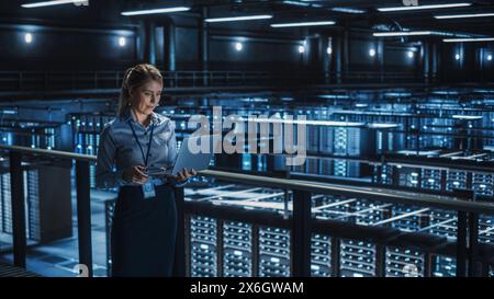 Data Center Female It Specialist Using Laptop. Server Farm Cloud Computing and Cyber Security Maintenance Administrator Working on Computer. Information Technology Professional. Stock Photo