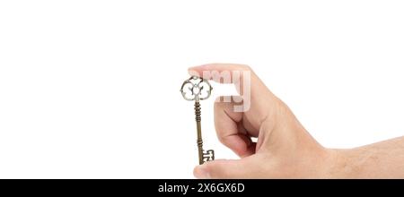 Vintage retro key in hand. Highlighted on a white background. A place to copy Stock Photo