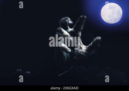 Zombie hand reaching for the full moon. Halloween concept Stock Photo