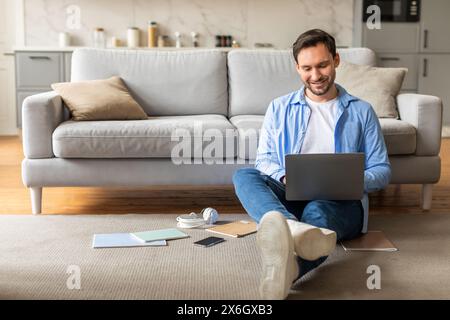 Man Sitting on Floor With Laptop, Home Interior Stock Photo