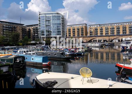 Boats, barges and narrowboats of all shapes, sizes and colours moored at Limehouse Basin in East London on 7th May 2024 in London, United Kingdom. Limehouse Basin in Limehouse, in the London Borough of Tower Hamlets provides a navigable link between the Regents Canal and the River Thames, through the Limehouse Basin Lock. Stock Photo
