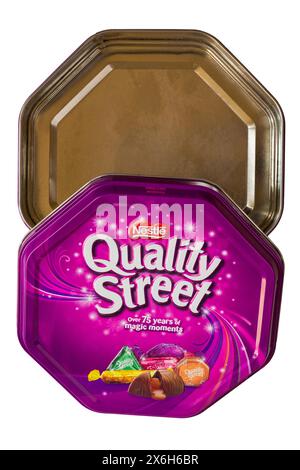 Empty Nestle Quality Street chocolates sweets metal tin isolated on white background - all gone, eaten all of them concept Stock Photo