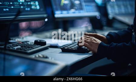 Close Up of a Professional Office Specialist Working on Desktop Computer in Modern Technological Monitoring Control Room with Digital Screens. Manager Typing on keyboard and Using Mouse. Stock Photo