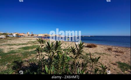 Italy, Sicily, Marzamemi (Siracusa province), fishing boats in the harbour and the old tuna fishing factory buildings Stock Photo