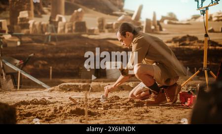 Archaeological Digging Site: Great Male Archeologist Work on Excavation Site, Carefully Cleaning Newly Discovered Ancient Civilization Cultural Artifact, Historic Clay Tablet, Fossil Remains Stock Photo