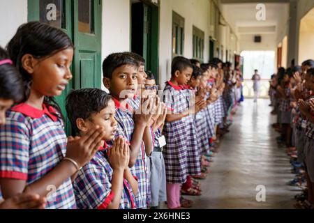 Kolkata, India - 20 October 2024: children in uniform praying and singing the national anthem for indian school morning routine. Concept of growth, ed Stock Photo