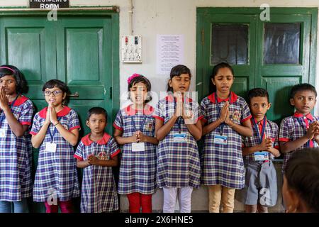 Kolkata, India - 20 October 2024: children in uniform praying and singing the national anthem for indian school morning routine. Concept of growth, ed Stock Photo