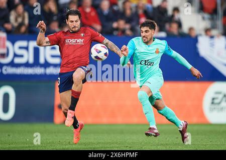 Juan Cruz of CA Osasuna compete for the ball with Nacho Vidal of RCD Mallorca during the LaLiga EA Sports match between CA Osasuna and RCD Mallorca at Stock Photo