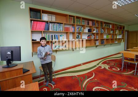 Library of the medrese. Muslim boy reading a book. October 21, 2018. Islamic culture centre, Kiev, Ukraine Stock Photo