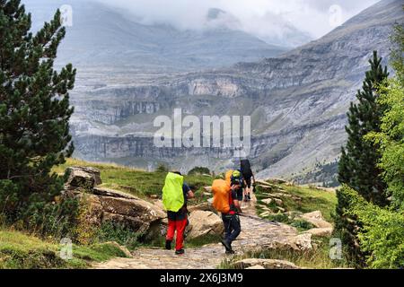 PYRENEES, SPAIN - SEPTEMBER 25, 2021: Backpackers enjoy a hiking trail in Ordesa y Monte Perdido National Park in Pyrenees. Stock Photo