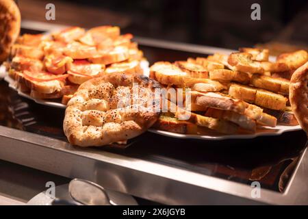 Turkish flatbread and bruschetta on buffet table in hotel Stock Photo