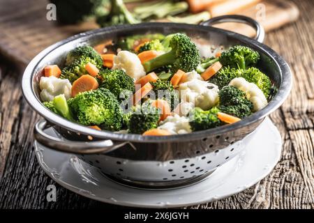 Broccoli, carrots and cauliflower in stainless steel steamer Stock Photo