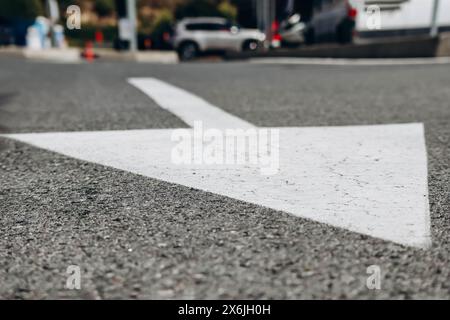 Close-up of a white arrow on the road Stock Photo