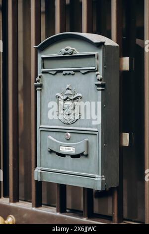 Typical vintage Italian mailboxes in grey, on a white wall Stock Photo