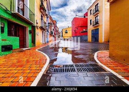 Houses reflected in puddles in the old town of Villajoyosa Stock Photo