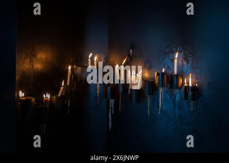 Burning candles in the interior of the Chapel of Santa Catarina, Chapel of Souls or Capela das Almas, decorated with  blue azulejo tiles in the old to Stock Photo