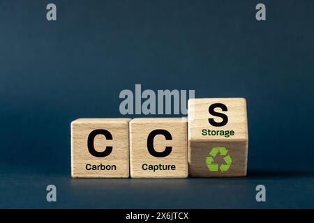 CCS Carbon capture storage symbol. Concept words CCS Carbon capture storage,ecological icon and text on wooden blocks. navy blue background. Business Stock Photo