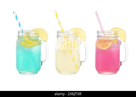 Cold, colorful summer lemonade drinks. Blue, yellow and pink colors in mason jar glasses isolated on a white background. Stock Photo