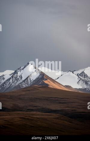 Mountains, glacier and autumnal grass. High mountain landscape with ...