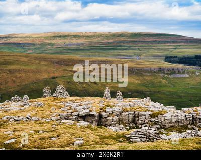 A line of ancient stone cairns on top of the hills in Littondale in the Yorkshire Dales. These are a remote location and appear to be ancient. Stock Photo