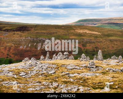 A line of ancient stone cairns on top of the hills in Littondale in the Yorkshire Dales. These are a remote location and appear to be ancient. Stock Photo