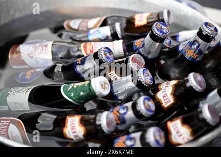 Bottles of variety of beers cooling in cold water bath Stock Photo