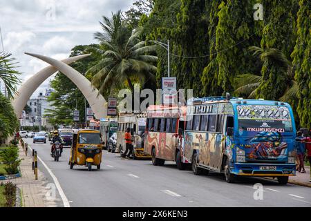 Colorful buses and the Mombasa Tusks monument on Moi Avenue, Mombasa, Kenya, Africa Stock Photo