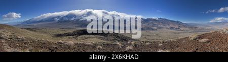 panorama of the Sierra Nevada Mountains with clouds covering the summits from the top of Crater Mountain in the Owens Valley near Big Pine California Stock Photo