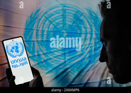 Brussels, Belgium. 15th May, 2024. The UNRWA logo is displayed on a smartphone with United Nations icon visible in the background in this photo illustration. Taken in Brussels, Belgium. On May 15, 2024. (Jonathan Raa/Sipa USA) *** Strictly for editorial news purposes only *** Credit: Sipa USA/Alamy Live News Stock Photo