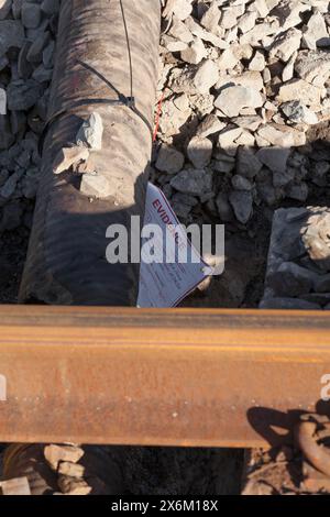 Rail Accident investigation branch tag on  water pipe damaged by a tamping machine at the site of the train derailment at Grange Over Sands March 2024 Stock Photo