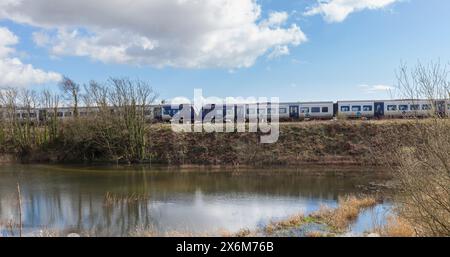 24/3/24 Grange Over Sands, Cumbria. Northern Rail train that derailed on 22 March after a sink-hole opened under the line with flooding visible Stock Photo