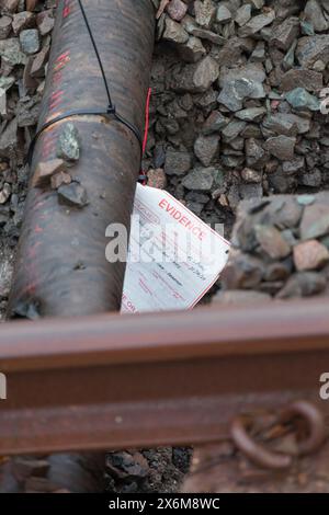 Rail Accident investigation branch tag on  water pipe damaged by a tamping machine at the site of the train derailment at Grange Over Sands March 2024 Stock Photo