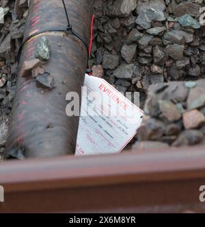 Rail Accident investigation branch tag on  water pipe damaged by a tamping machine at the site of the train derailment at Grange Over Sands March 2024 Stock Photo