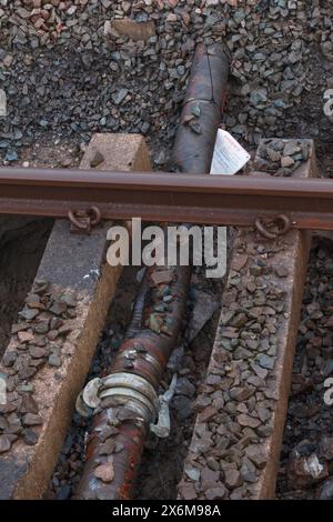 Rail Accident investigation branch tag on  water pipe damaged by a tamping machine at the site of the train derailment at Grange Over Sands March 2024 Stock Photo