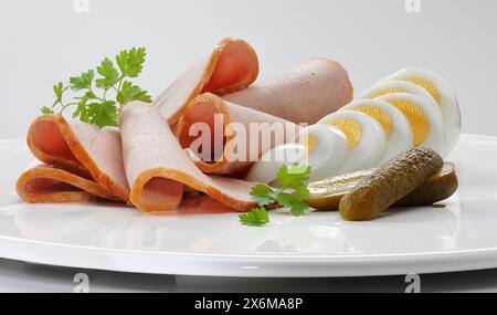 Liver loaf with hard-boiled egg and gherkin Stock Photo