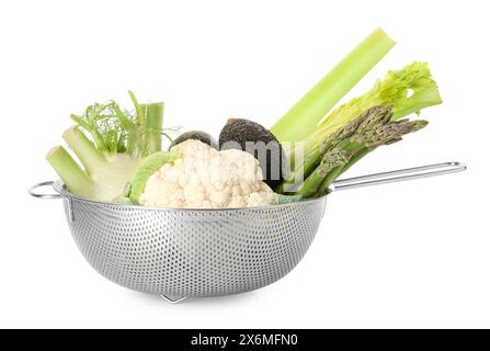 Metal colander with different vegetables and avocados isolated on white Stock Photo