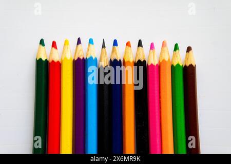 A Row Of Colored Pencils Are Lined Up On A White Table. Stock Photo