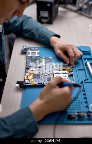 top view on technician or Engineer installing CPU microprocessor to motherboard socket on workplace in the office. Concept of repairing, upgrade, serv Stock Photo