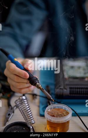 Professional engineer restores the laptop PC using various special tools. Electronic repair shop, technology renovation, business, concept repairs. ma Stock Photo