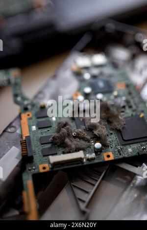 disassembled laptop. laptop repair and maintenance.dust and dirt in the laptop system, laptop part close-up photo, focus on disassembled detail Stock Photo