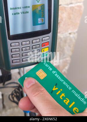 Bordeaux , France -  05 15 2024 : Carte vitale french health insurance card man holding Carte Vitale of the national health care system updated on com Stock Photo