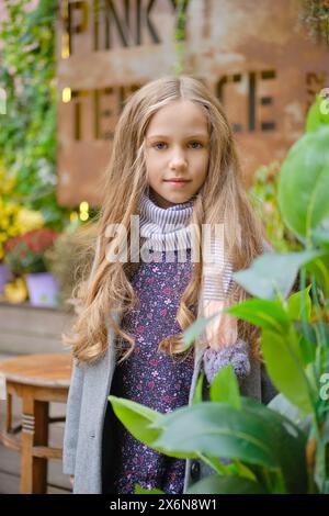 Outdoor portrait of pretty little girl with long curly hair Stock Photo