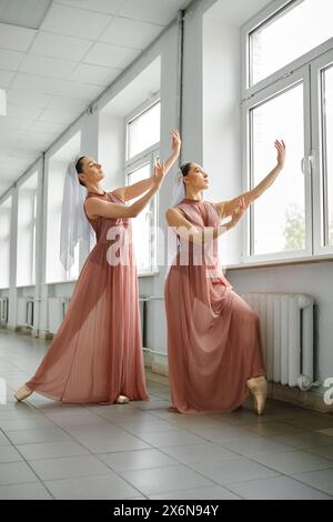 Two ballet dancers rehearsing moves in the hallway Stock Photo