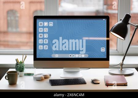 Front view background image of PC computer on simple desk setup against window copy space Stock Photo