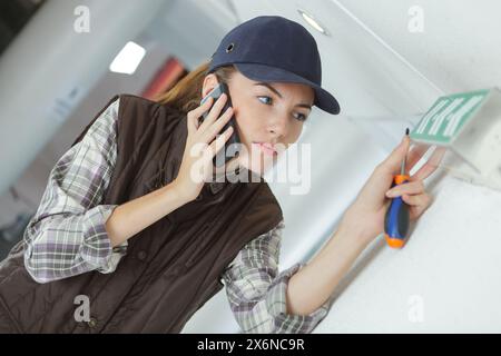 pretty female cctv installing security camera Stock Photo